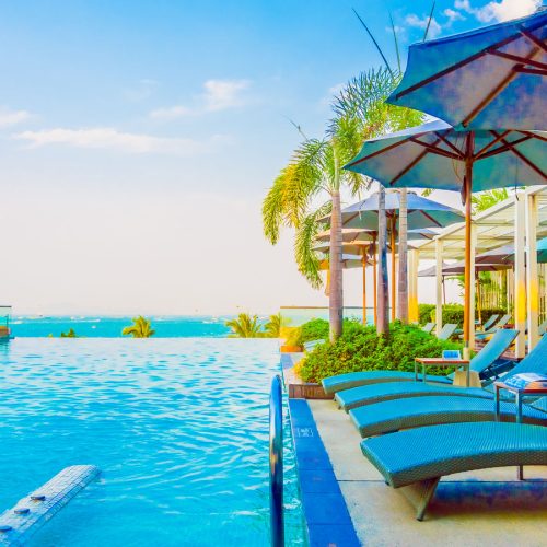 Beautiful luxury swimming pool with umbrella and chair in luxury hotel resort - Boost up color Processing style